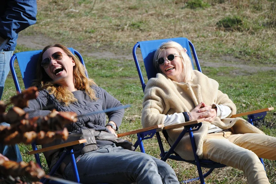 Couple laughing together in deck chairs outdoors